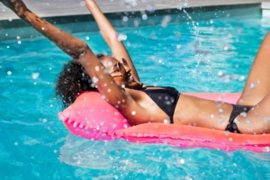 girl on float chaise in pool